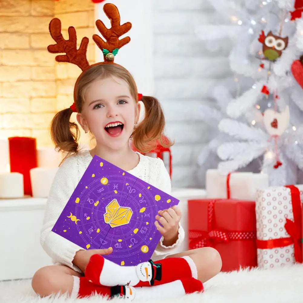 Child wearing reindeer antlers holding a purple card with a Christmas tree and presents in the background