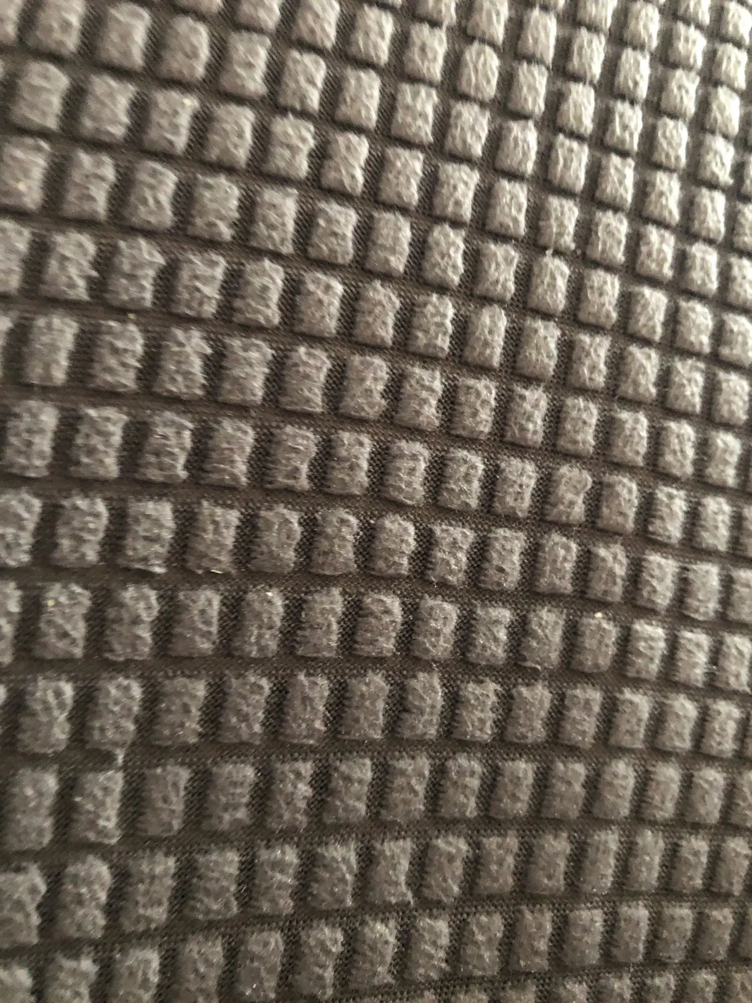 Close-up of textured brown fabric with a diamond pattern